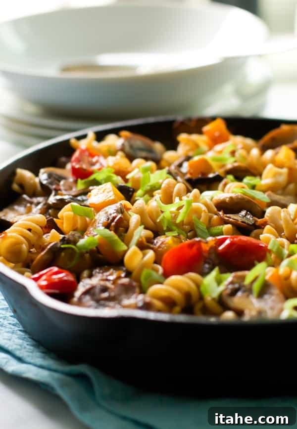 Fusilli with Mushroom and Roasted Butternut Squash A vibrant close-up of Fusilli with Mushroom and Roasted Butternut Squash, showcasing the pasta coils, golden squash, and earthy mushrooms.