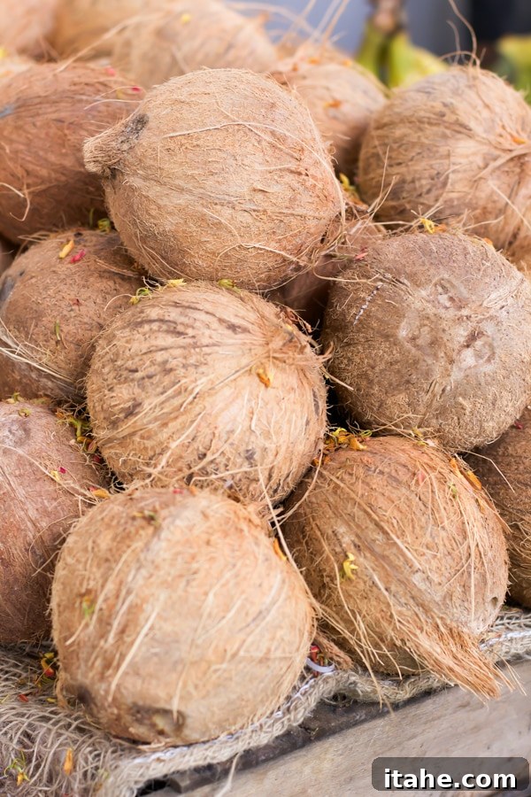 Brazilian Feiras: A Taste of Local Life 5 A close-up shot of a large, inviting pile of fresh coconuts resting on a rustic wooden table at a vibrant market.