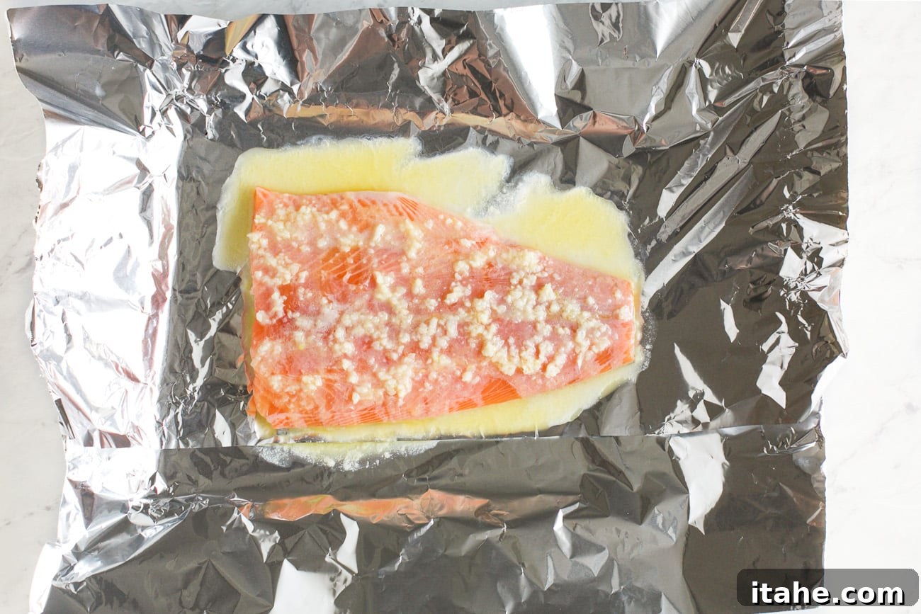 Mouthwatering Garlic Butter Salmon 5 salmon in a baking sheet with melted butter mixture on top
