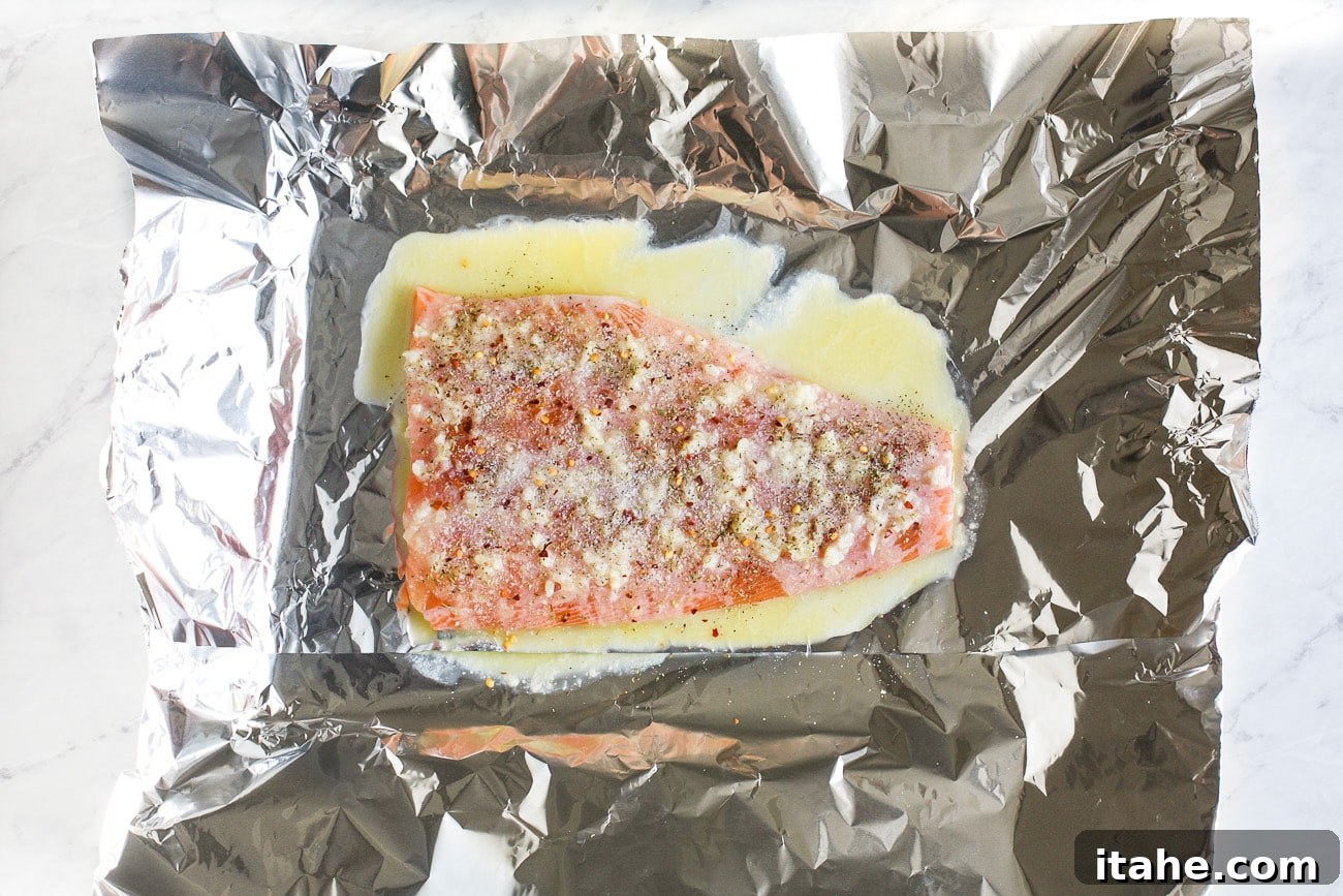 Mouthwatering Garlic Butter Salmon 6 salmon in a baking sheet with melted butter mixture on top