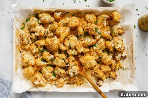 Roasted Cauliflower on a baking sheet, garnished with parsley.