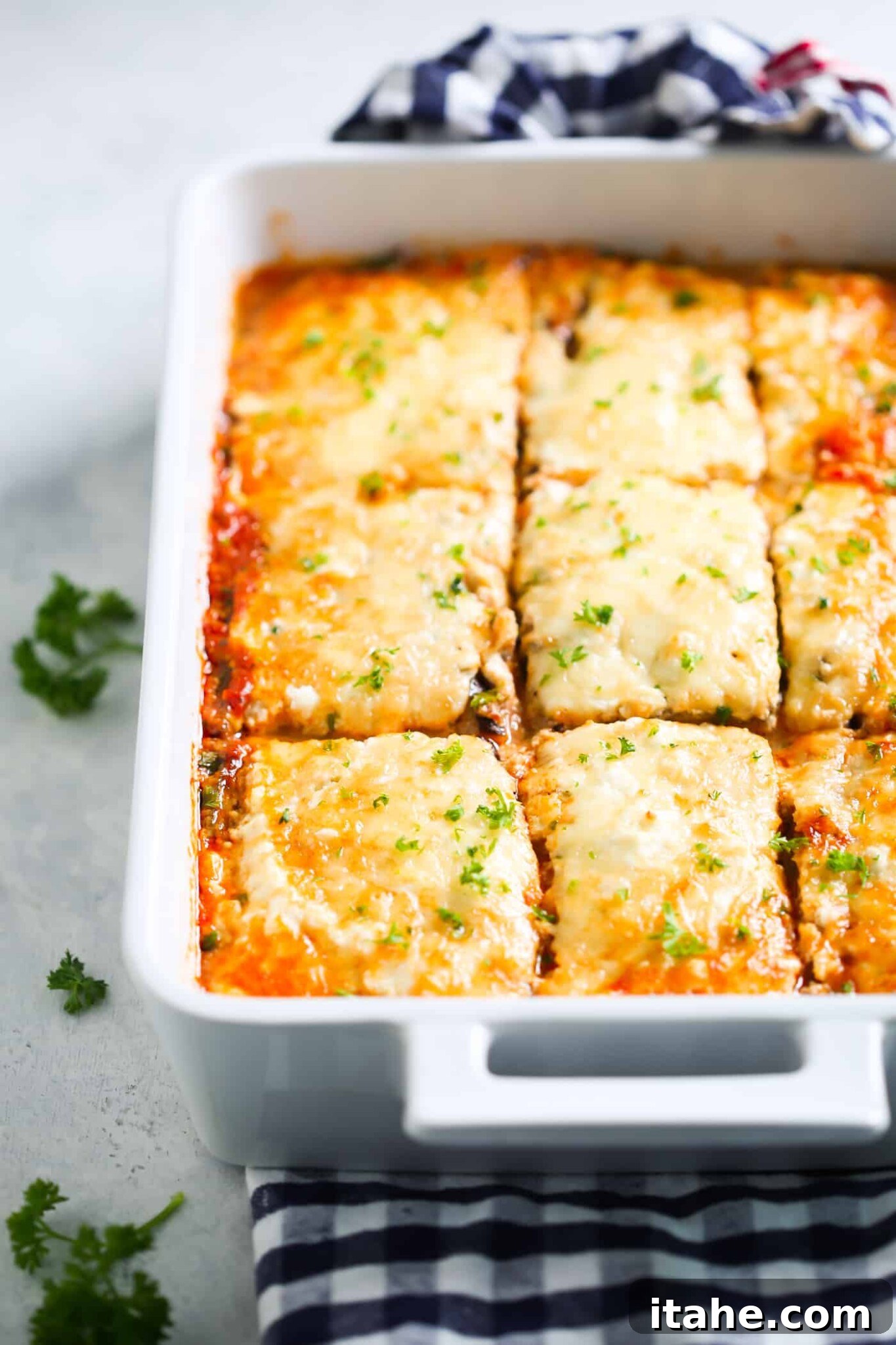 Perfectly Baked Low-Carb Eggplant Lasagna - A comforting and wholesome meal. A freshly baked eggplant lasagna in a white baking dish, ready to be served.