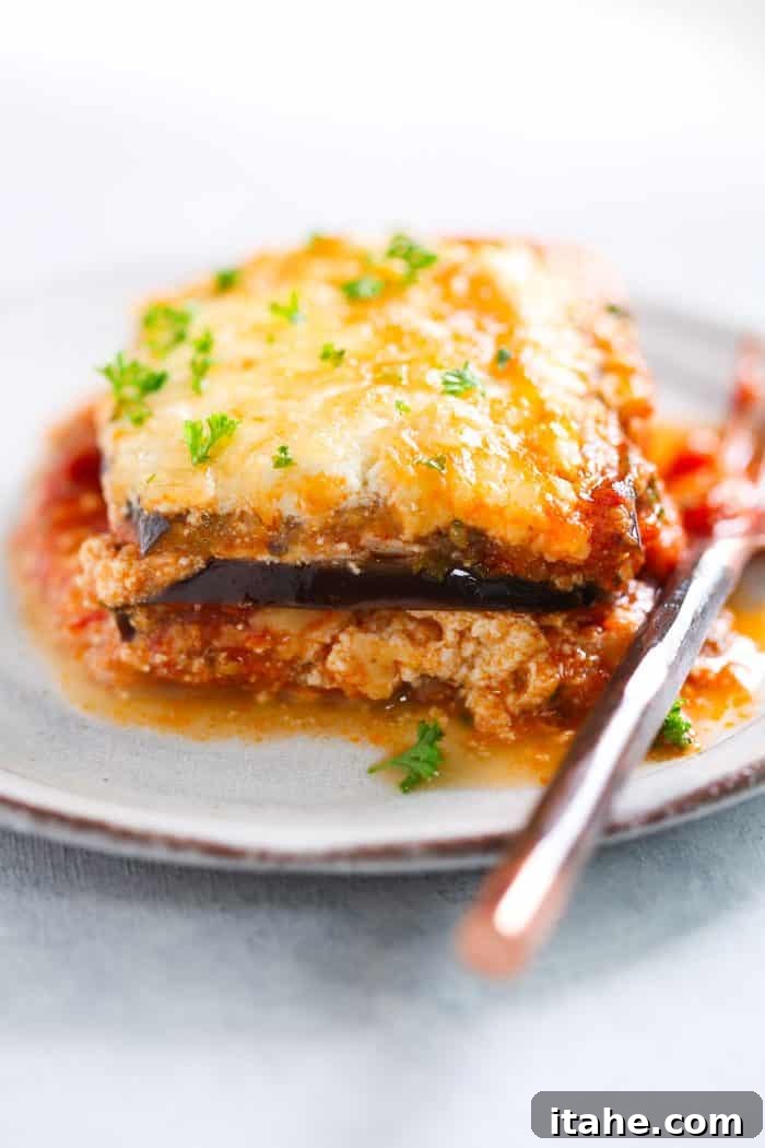 Serving Low-Carb Eggplant Lasagna - A delectable and satisfying dish. A single portion of eggplant lasagna on a white plate, showcasing its layers.