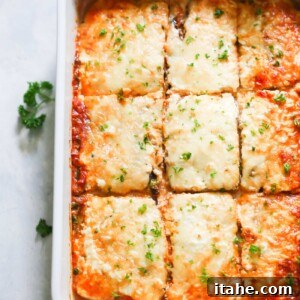 A baked eggplant lasagna, golden brown and cheesy, ready to serve.