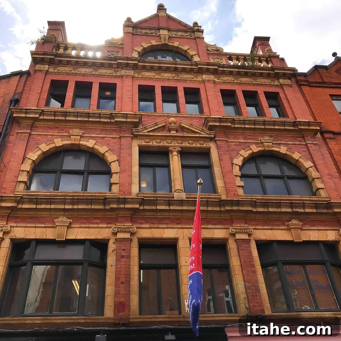A striking red building with classic architecture on a Dublin street