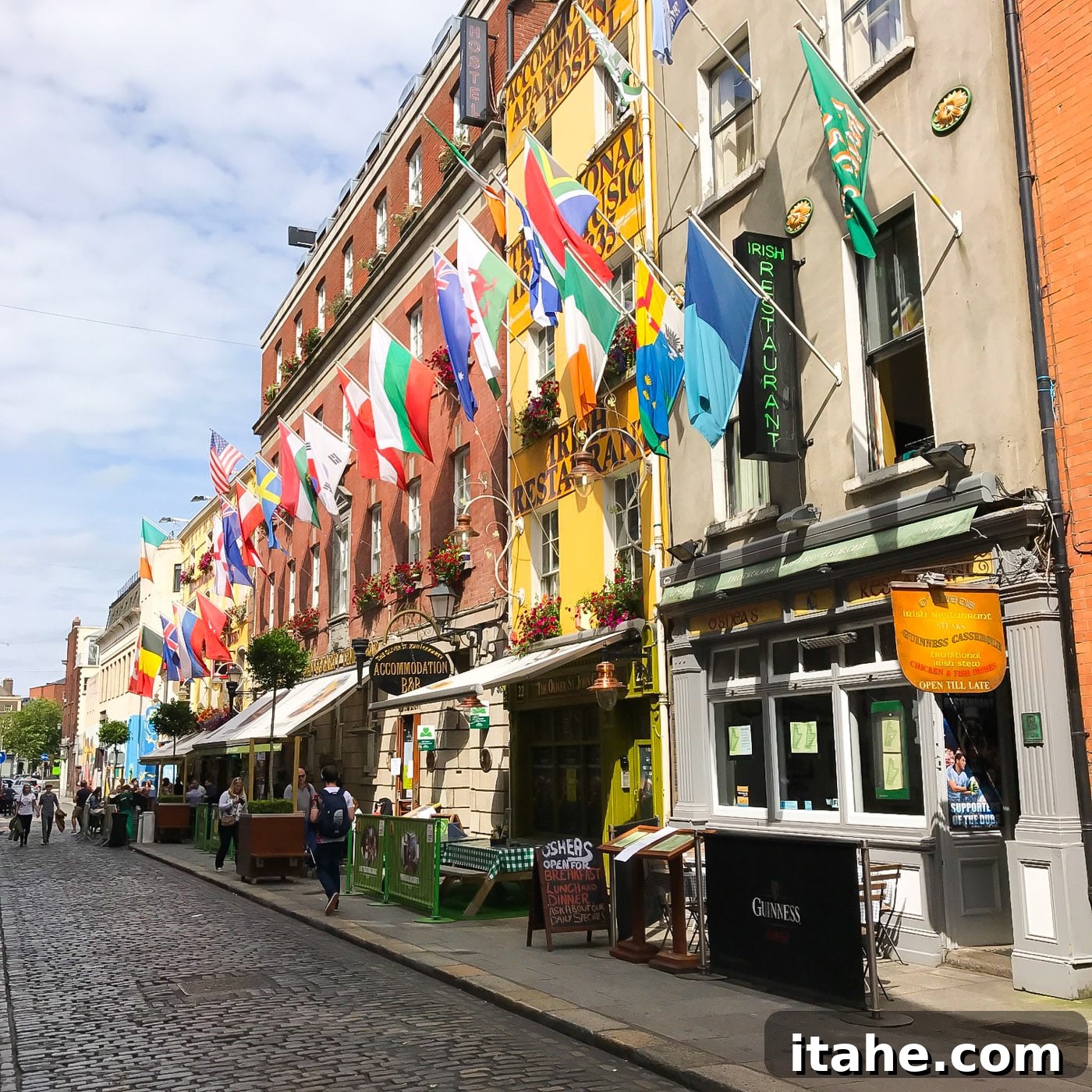 A beautifully adorned street in Dublin, showcasing colorful flags and elegant buildings