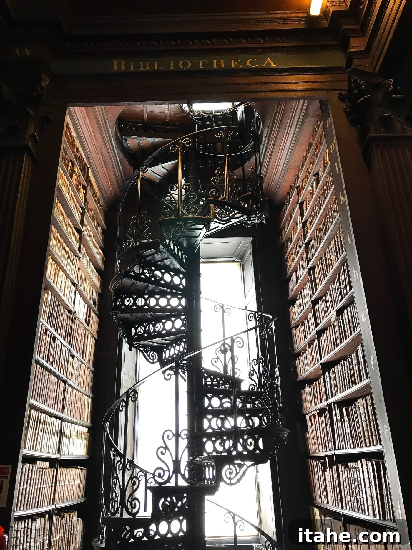 A sweeping view of the majestic stairs within the Library of Trinity College Dublin