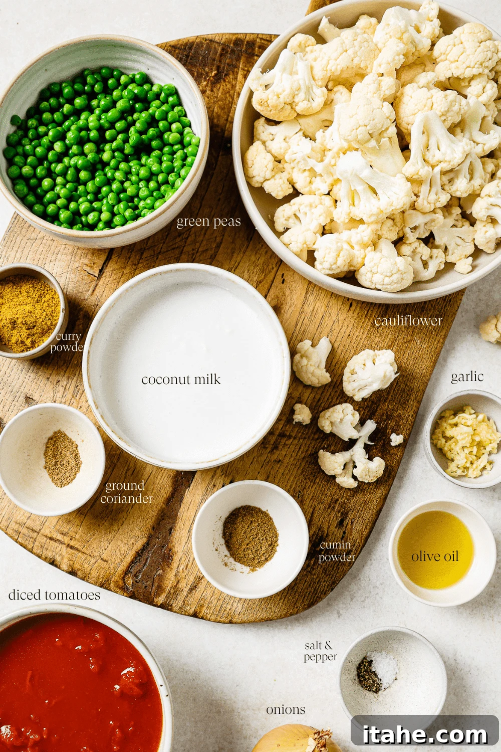 Pre-measured ingredients in small bowls on a wooden cutting board. 