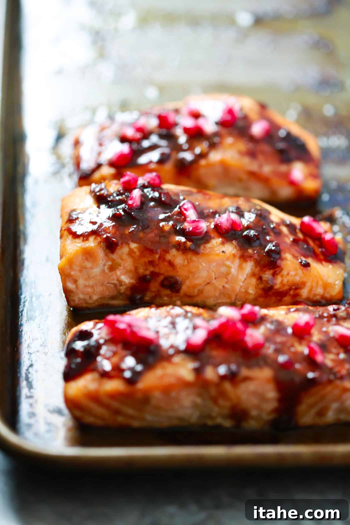 The easiest Pomegranate Glazed Salmon you will ever make. It only requires 4-ingredient and the glaze has no added sugar, but has a delicious tangy flavor! A perfectly cooked salmon fillet, glistening with a vibrant pomegranate glaze, ready to be served.