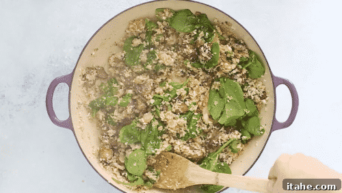 Low-Carb Cauliflower Rice 12 Spinach wilting into cauliflower rice