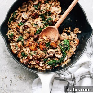 Low-Carb Cauliflower Rice 5 overhead view of a white skillet contains Mushroom Cauliflower Rice