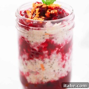 Delicious Cranberry Oatmeal prepared and served in a glass jar, showing layers of creamy oatmeal and vibrant cranberry sauce.