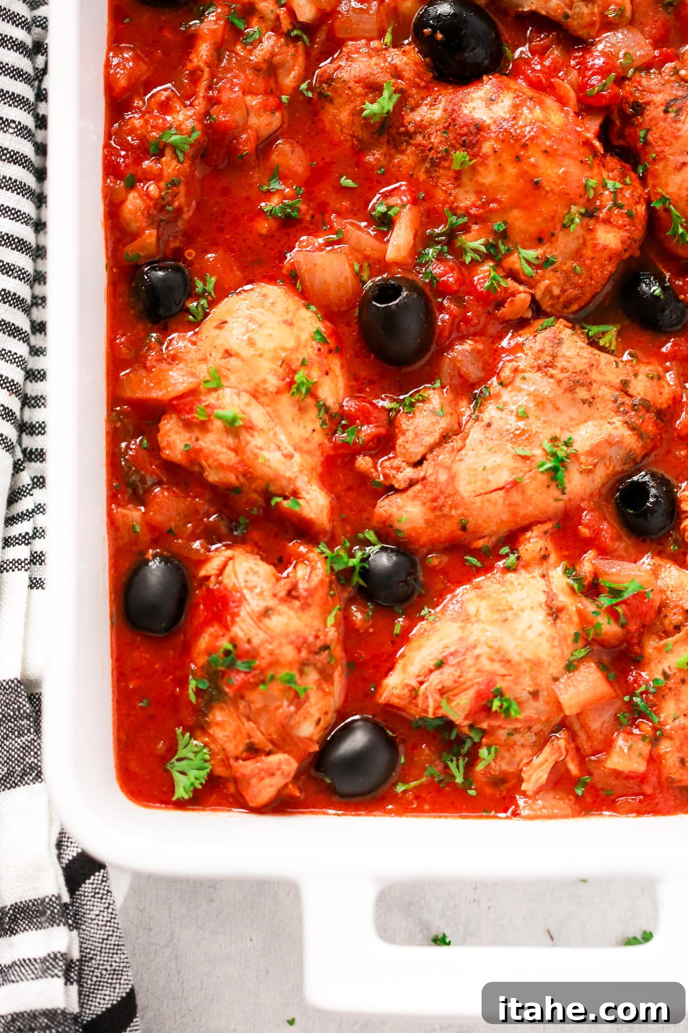 Quick Instant Pot Mediterranean Chicken 3 Chicken and tomato sauce in a white serving dish.