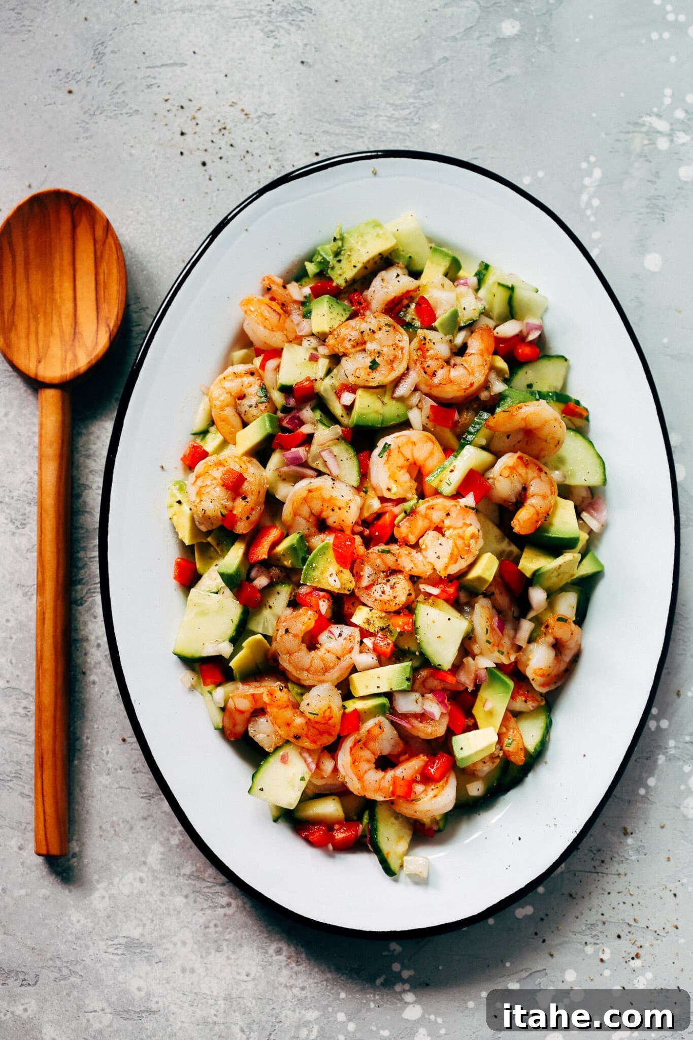 Fresh & Filling Low-Carb Lunches 15 An oval serving platter showcasing a fresh Shrimp Avocado Cucumber Salad, vibrant and appealing.