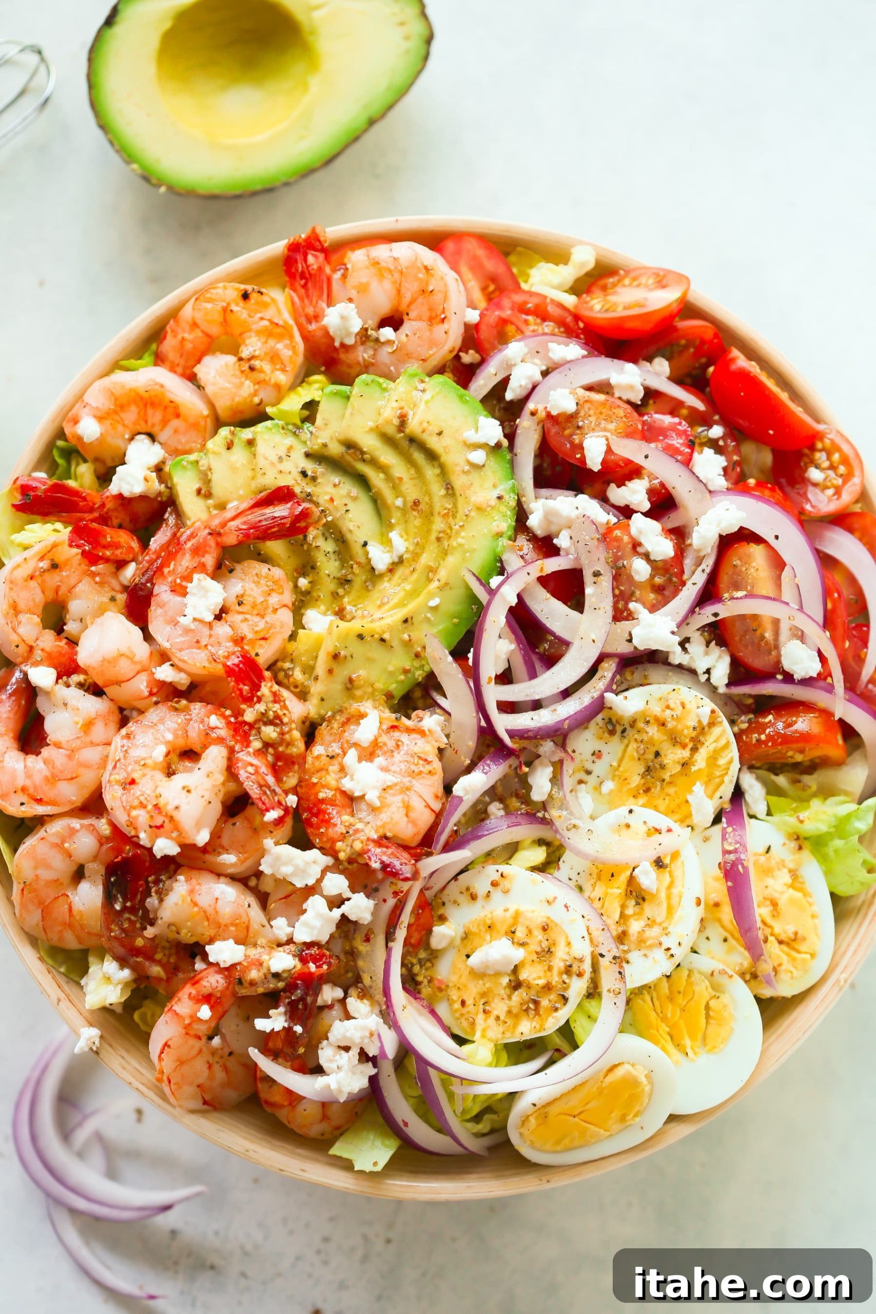 Fresh & Filling Low-Carb Lunches 5 Overhead view of a colorful bowl filled with Shrimp Avocado Tomato Salad, showcasing fresh ingredients.