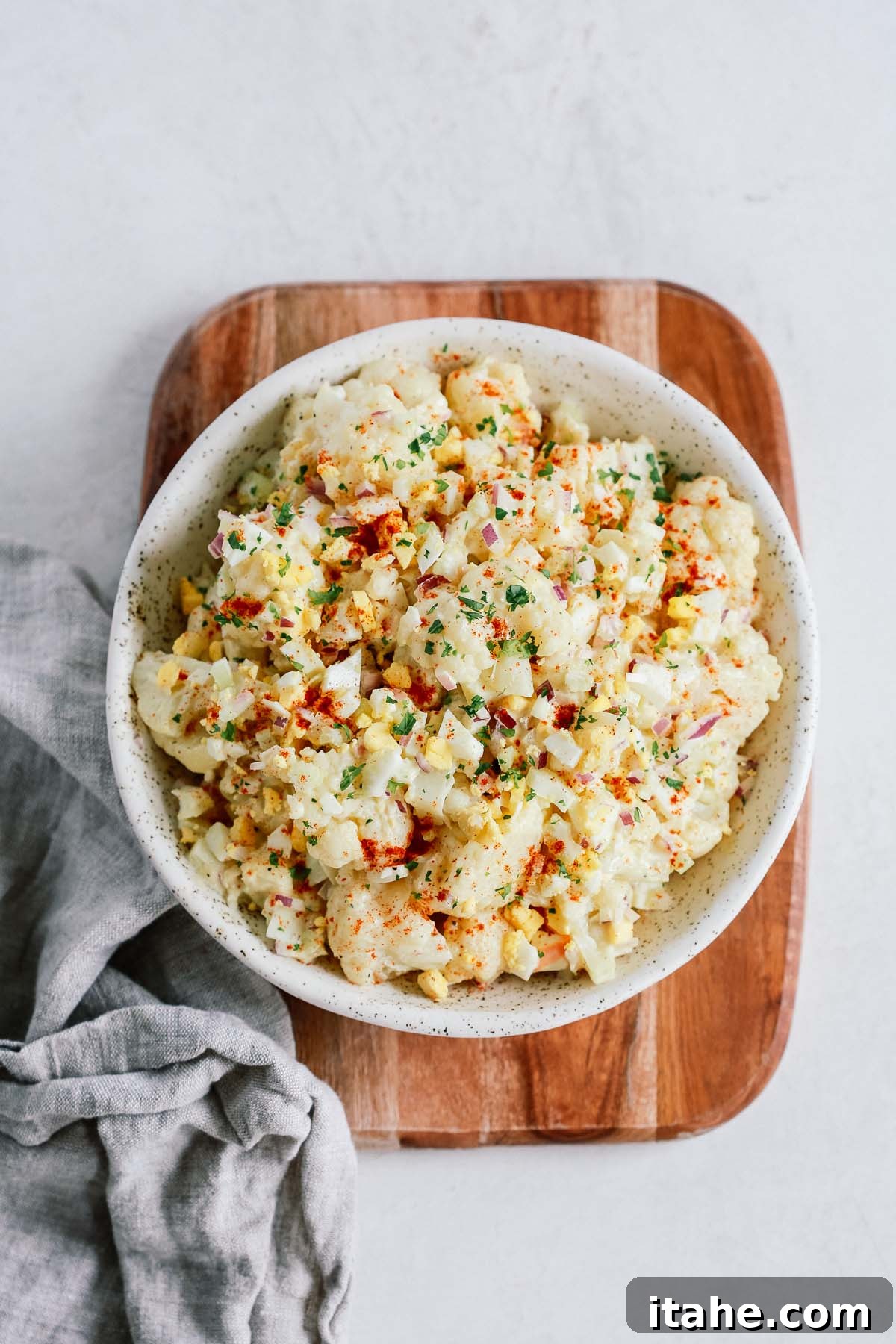 Fresh & Filling Low-Carb Lunches 7 Overhead view of a bowl containing creamy Cauliflower Potato Salad, mimicking the appearance of traditional potato salad.