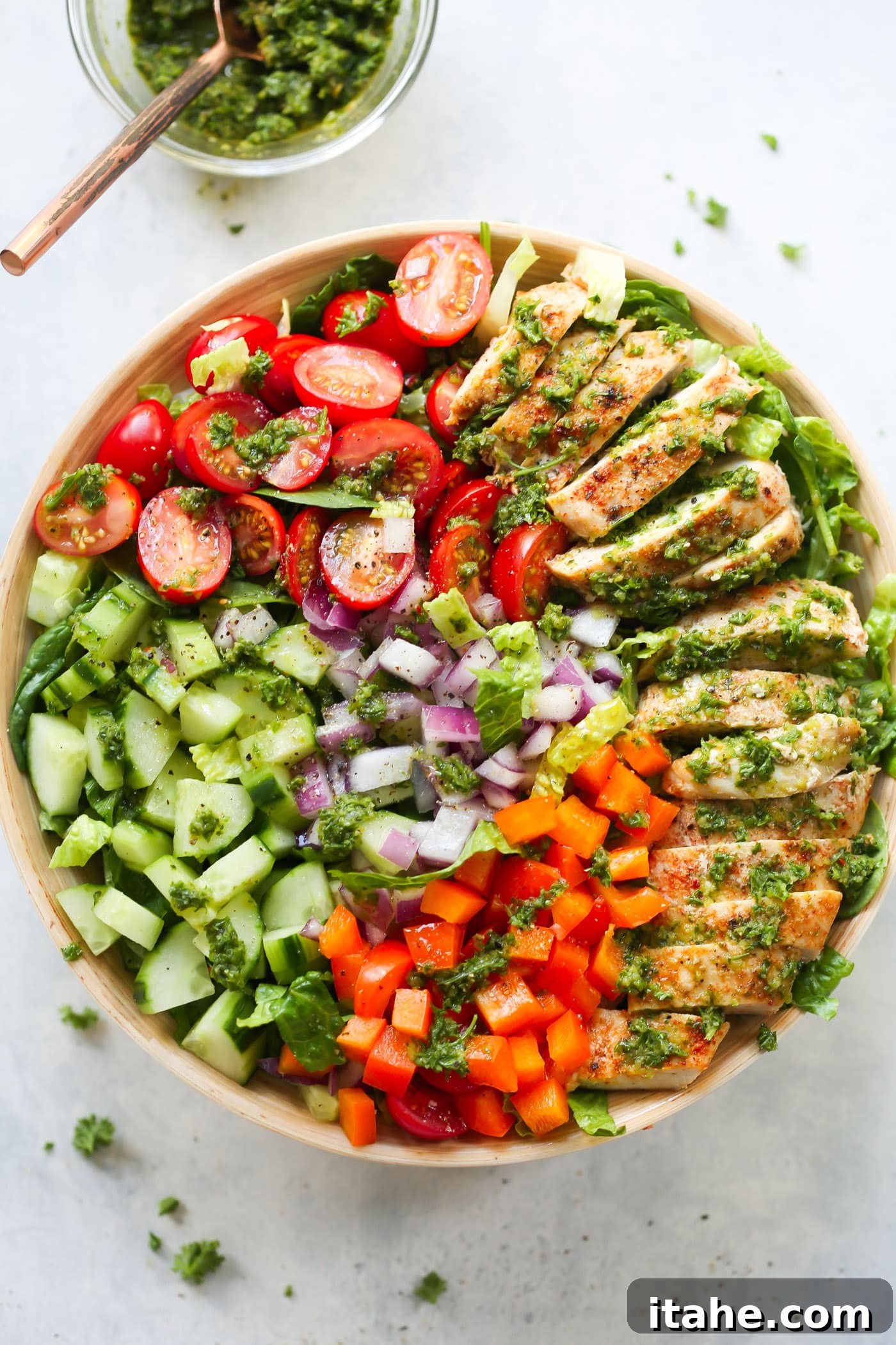 Fresh & Filling Low-Carb Lunches 8 Overhead view of a Chimichurri Chicken Chopped Salad bowl, showcasing the vibrant green sauce and chopped ingredients.