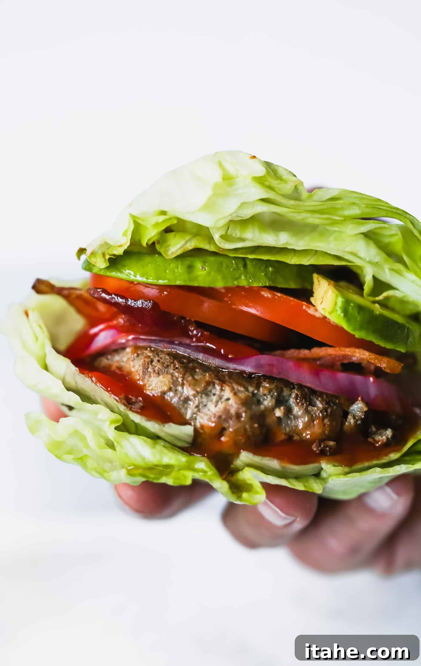 Delicious Bunless Burger Ideas 2 close up of Low-carb Bunless Burgers, showcasing a perfectly seared patty with fresh toppings.