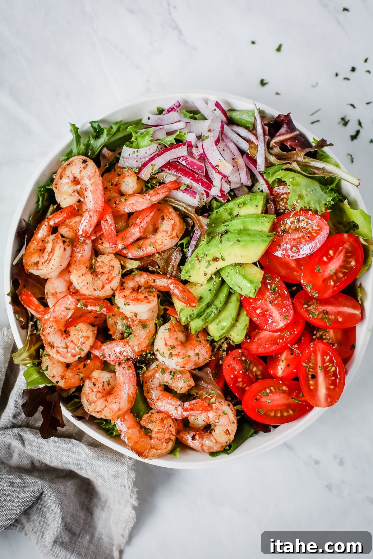 Bright Shrimp and Ripe Tomato Salad 3 Close-up of a bowl of Super Fresh Shrimp Tomato Salad with visible shrimp, tomatoes, avocado, and lettuce.