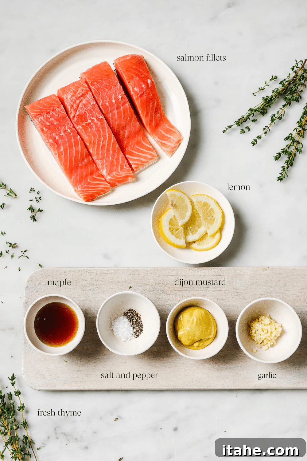 Pre-measured ingredients in small bowls on a cutting board and white countertop.
