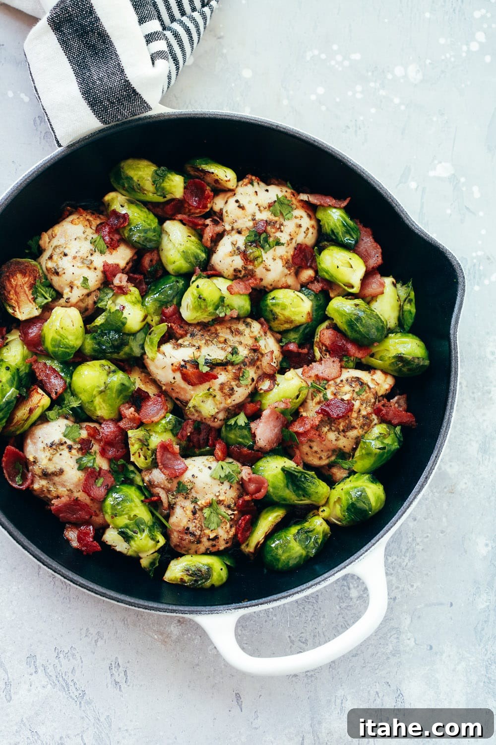 Crispy Chicken and Caramelized Brussels Bake 3 Close-up of garlic, lemon, and Dijon marinated chicken and Brussels sprouts in a skillet