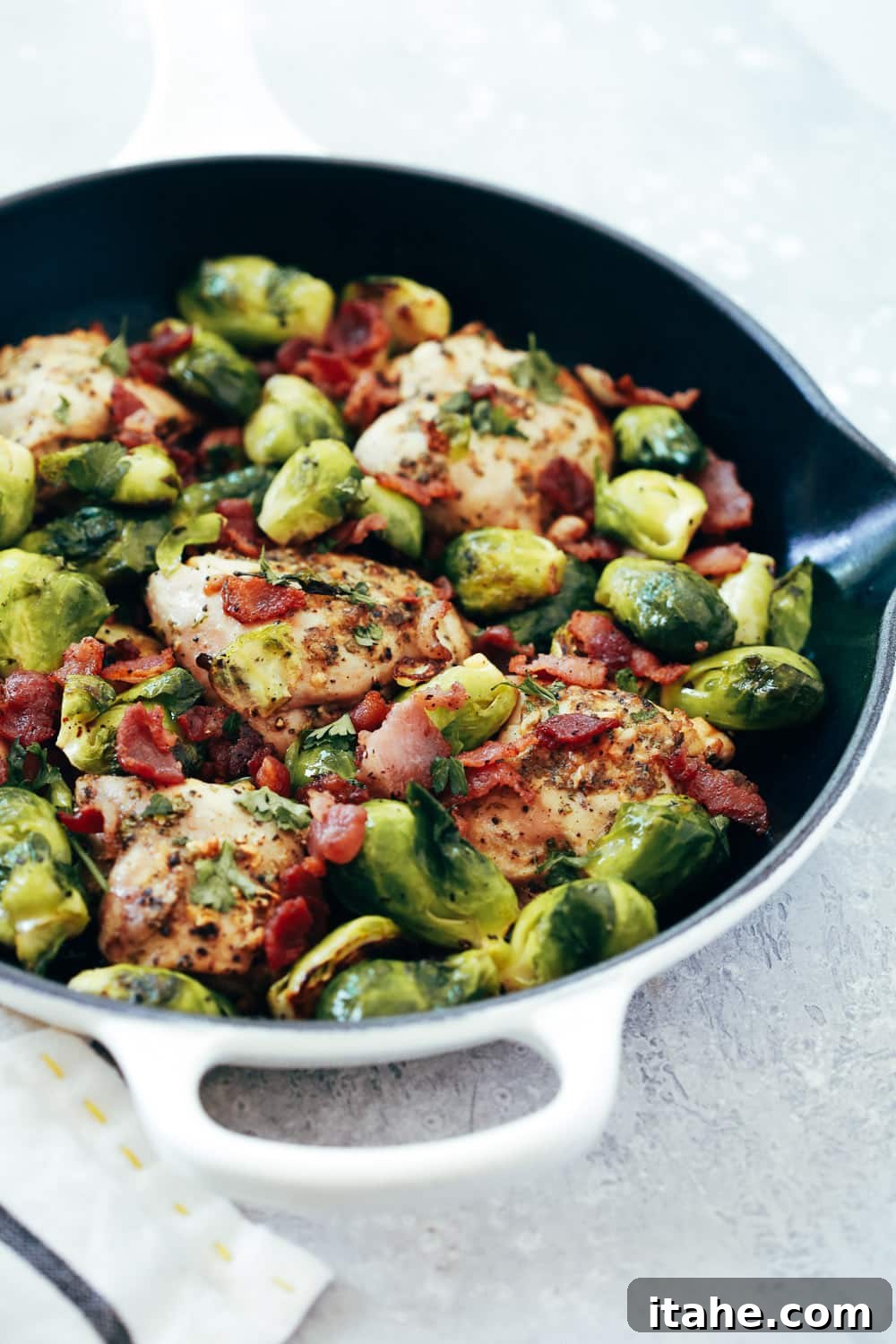 Crispy Chicken and Caramelized Brussels Bake 4 Close-up of a serving of baked chicken and Brussels sprouts with crispy bacon