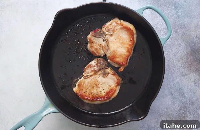 Mouthwatering Garlic Butter Baked Pork Chops 5 searing the pork chops in a cast iron