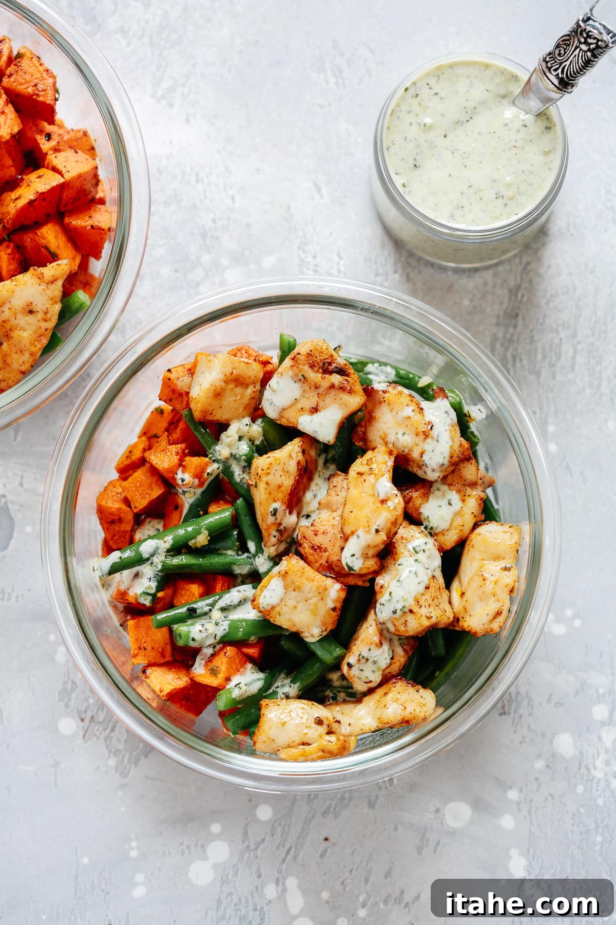 Healthy chicken and vegetable meal prep bowls with creamy pesto sauce, ready for a busy weeknight
