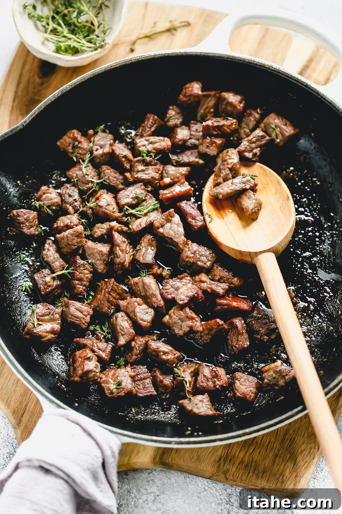 steak bites cooking in a skillet