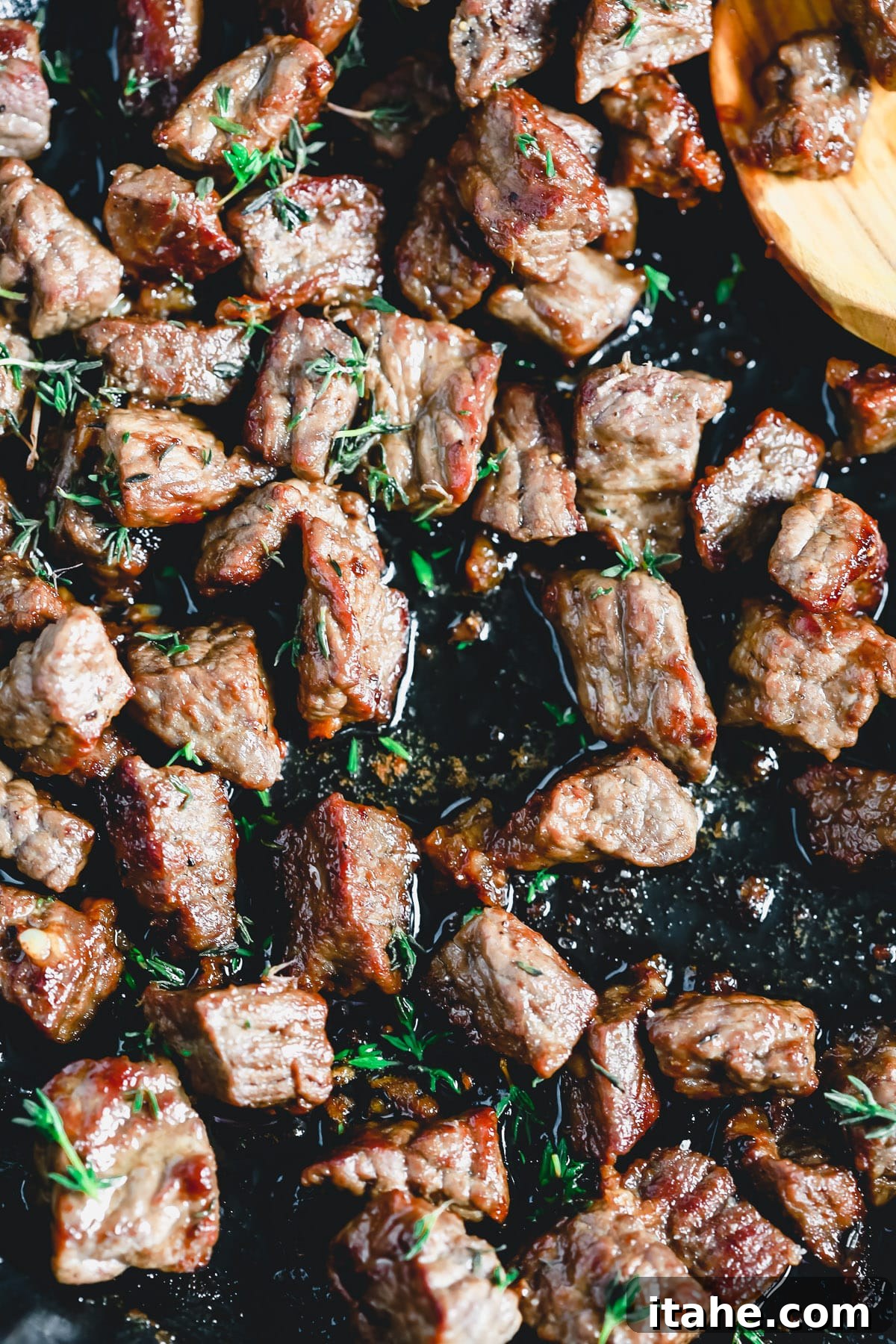 closeup image of sirloin steak bites in pan