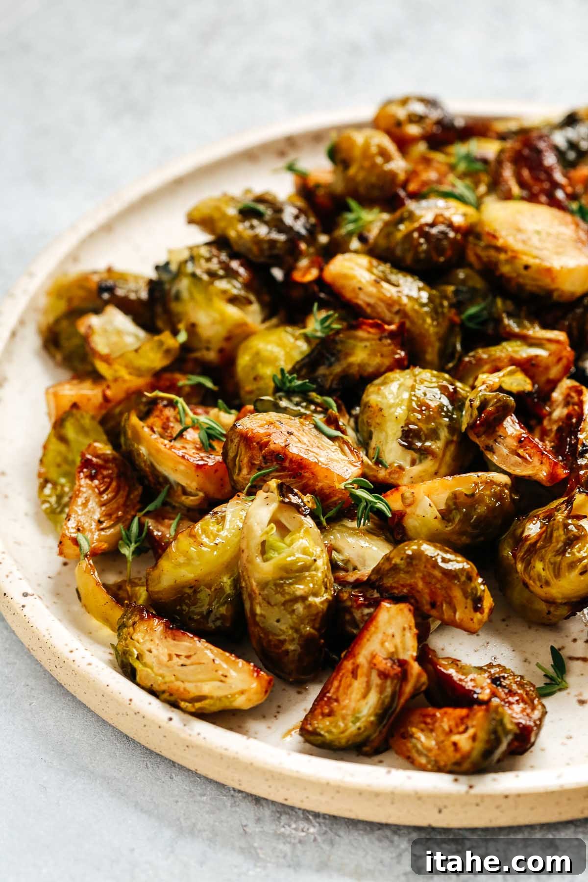 A beautiful serving platter overflowing with perfectly golden-brown roasted vegetables, ready for a festive meal.
