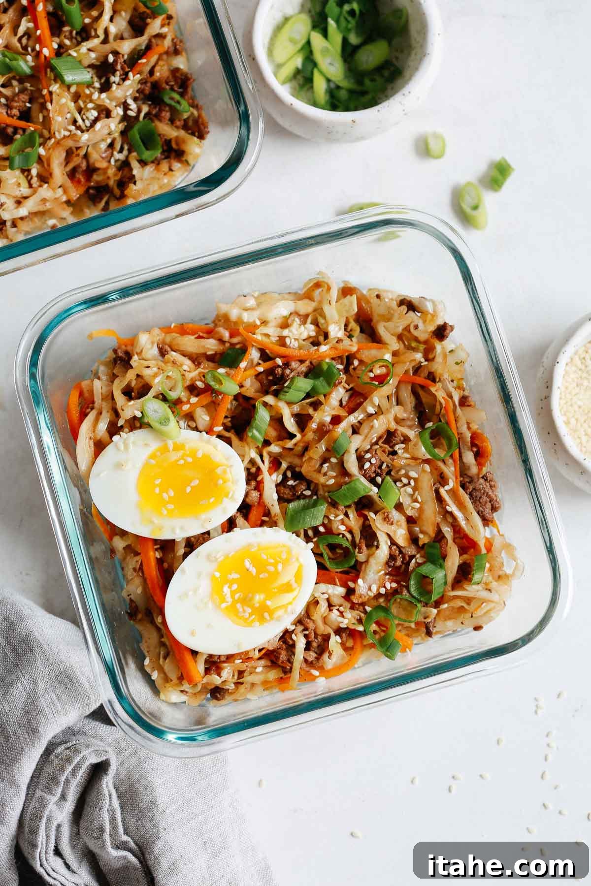Unwrapped Egg Roll Bowl 2 Overhead view of a vibrant Egg Roll in a Bowl recipe neatly packed into a glass meal prep container.