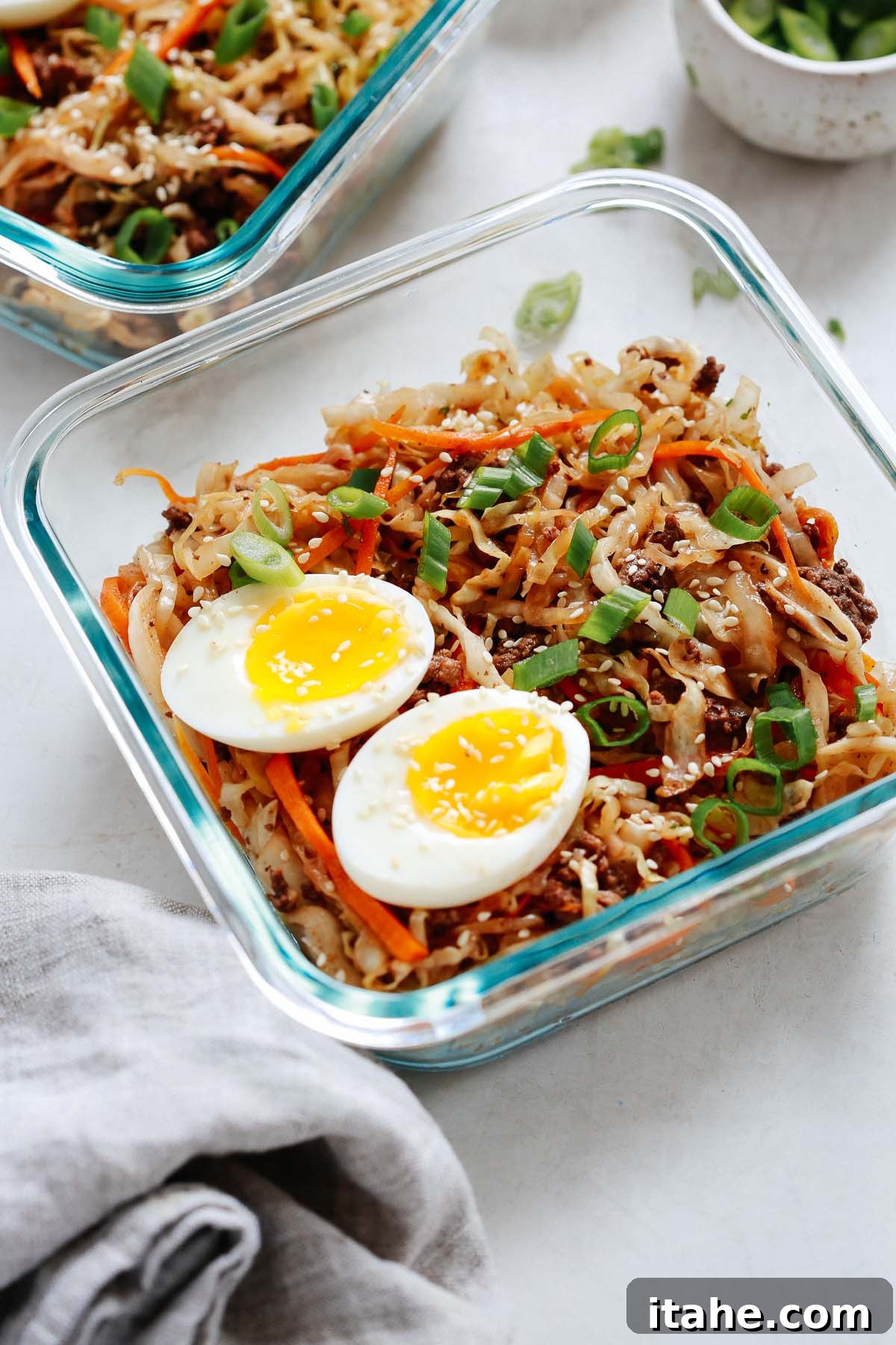 Unwrapped Egg Roll Bowl 6 Egg Roll in a Bowl with egg halves divided into meal prep containers.