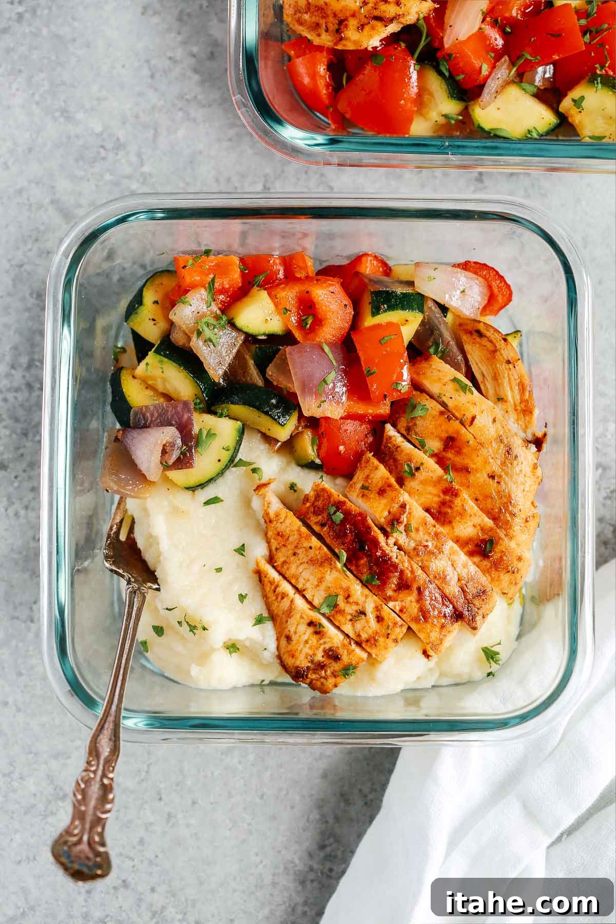 chicken breast with cauliflower mashed potatoes and steam vegetables in meal prep container