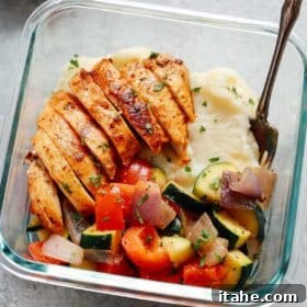 close up of a glass meal prep bowl containing low carb chicken meal prep bowls