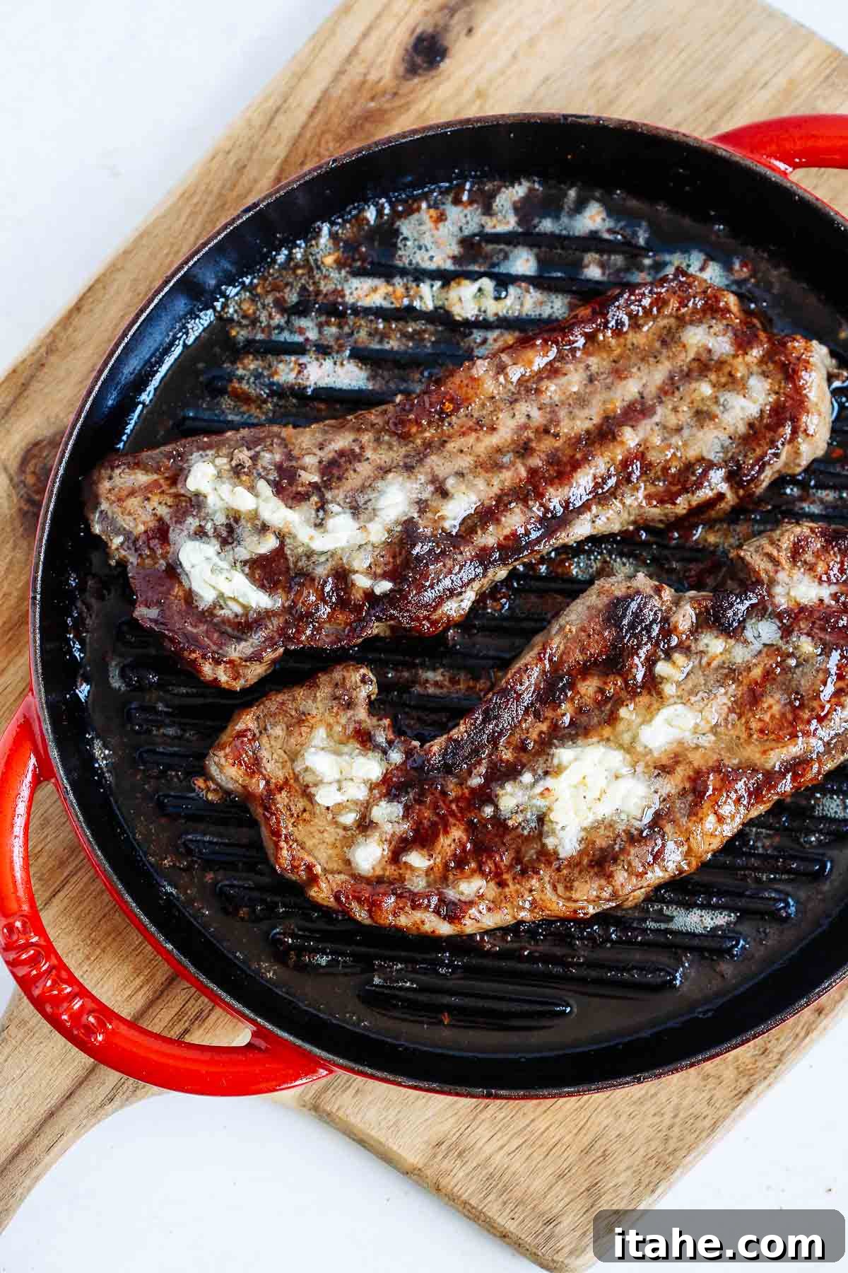 overhead view of garlic butter steak in a cast iron skillet