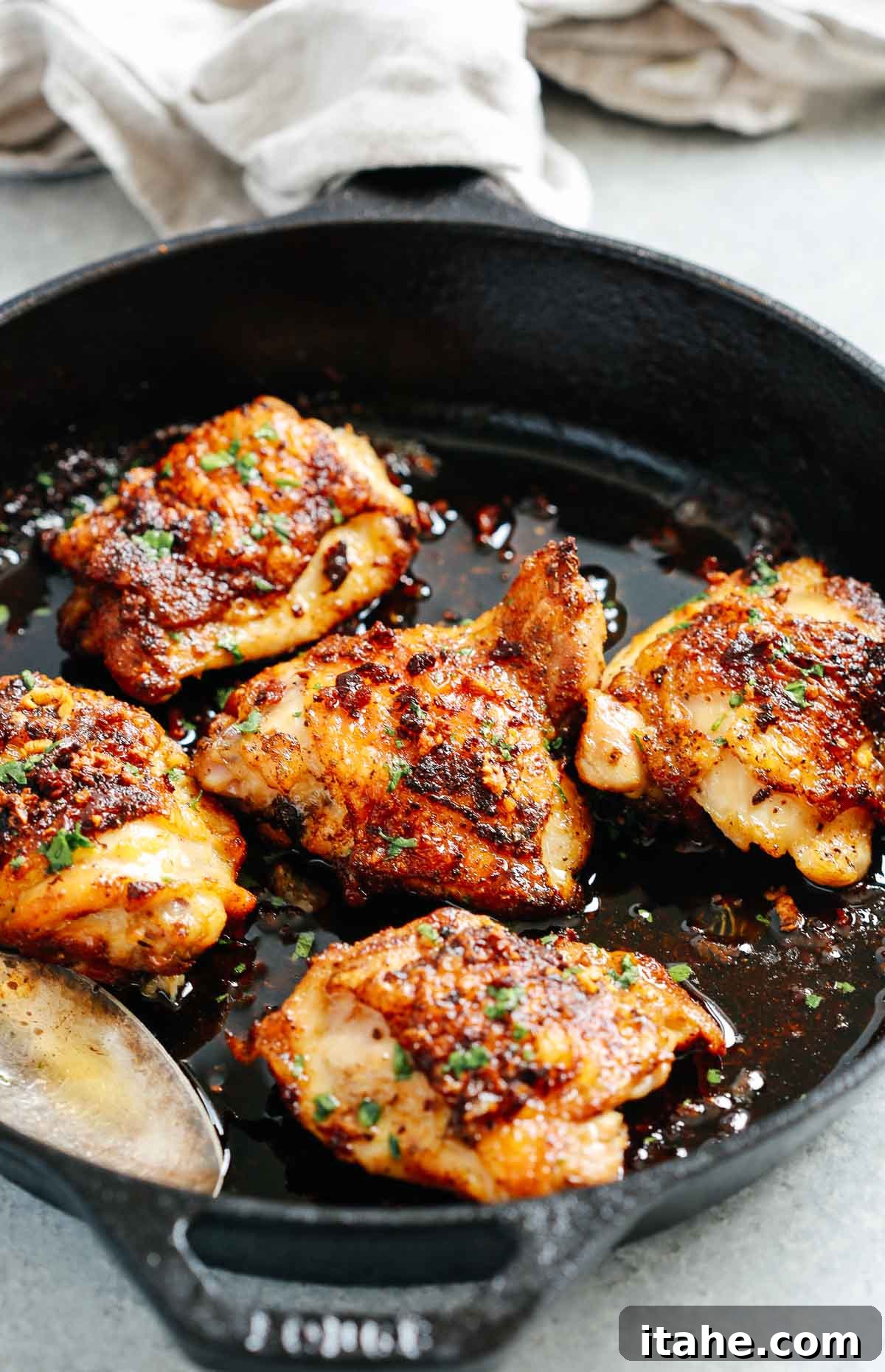 Close up of chicken thighs in a cast iron skillet