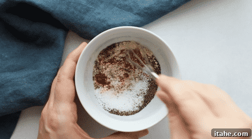 A white small bowl containing the mixed blackening spices.