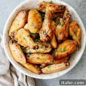 A bowl brimming with perfectly cooked, crispy salt and pepper chicken wings.