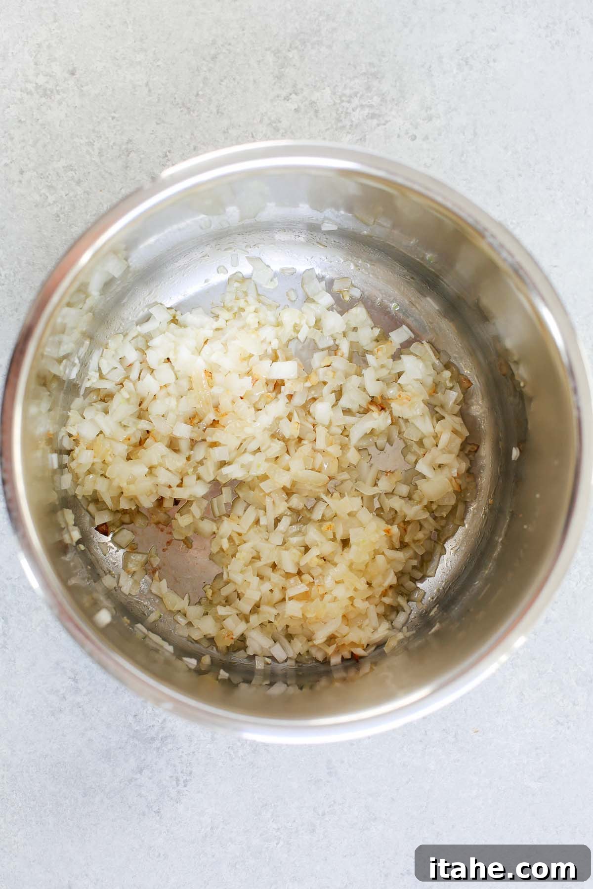 Instant Pot Fiesta Chicken Soup 3 Chopped onions, garlic, and bell peppers being sautéed to perfection in the Instant Pot liner, releasing aromatic steam.