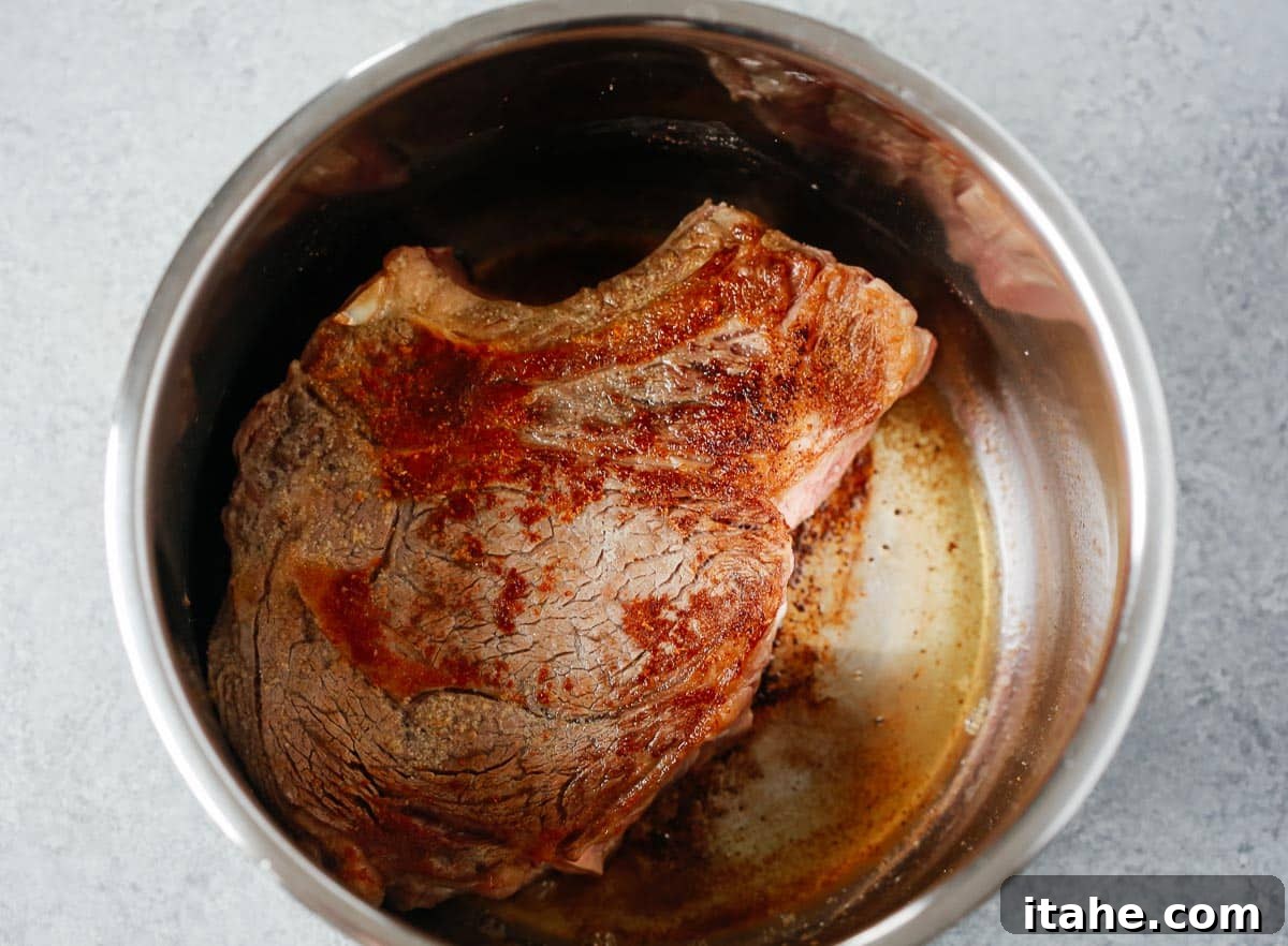 Chuck roast seared in a pressure cooker.