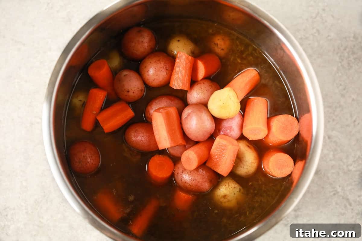 Vegetables being added to the Instant Pot.