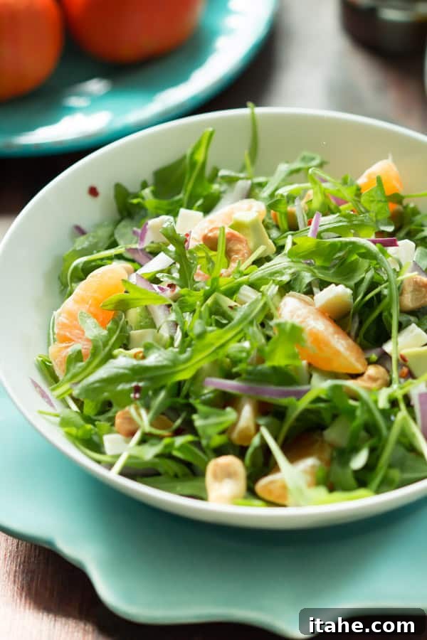 Arugula, clementine, avocado, and feta salad ready to be dressed.
