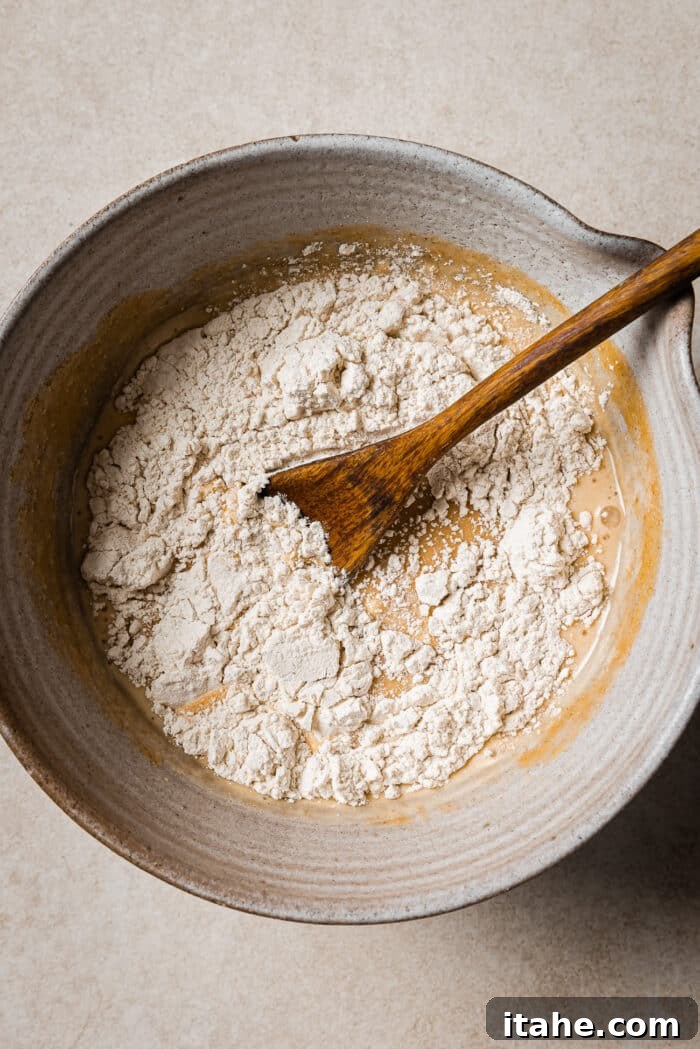 Creamy Peanut Butter Flapjacks 7 Flour is added to the bowl of wet pancake ingredients.