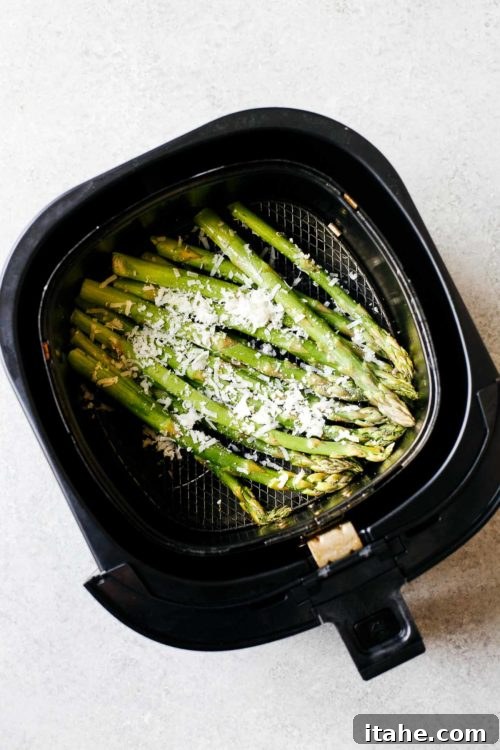 overhead view of asparagus inside of an air fryer