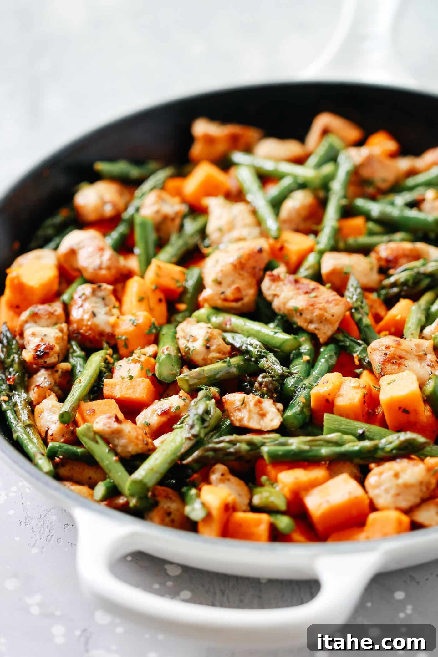 Golden Chicken Sweet Potato Bake 6 An overhead view of the completed chicken, sweet potatoes, and asparagus skillet, ready to be served.