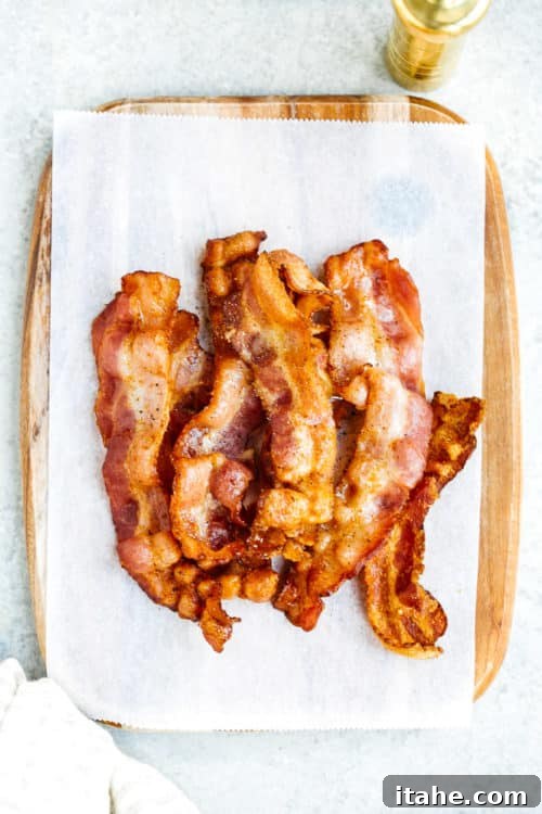 overhead view of cooked bacon on a white surface