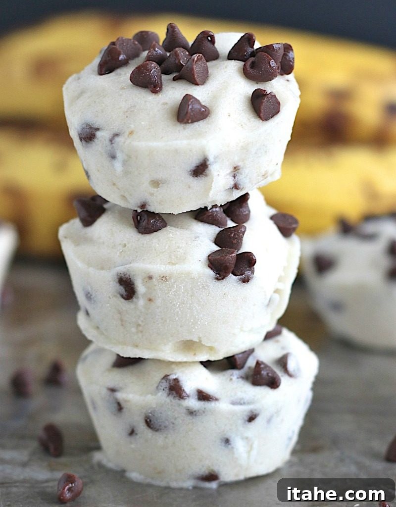 Indulge Wisely: Wholesome Ice Cream Treats 2 A stack of three banana chocolate chip ice cream bites topped with mini chocolate chips, presented on a rustic surface.