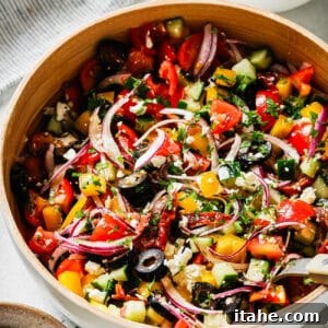 Freshly prepared Mediterranean Salad in a clean white bowl, showcasing its vibrant colors and delicious ingredients.