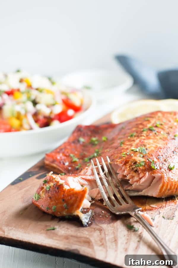 Cedar Plank Salmon cooking on a grill, infusing smoky flavor